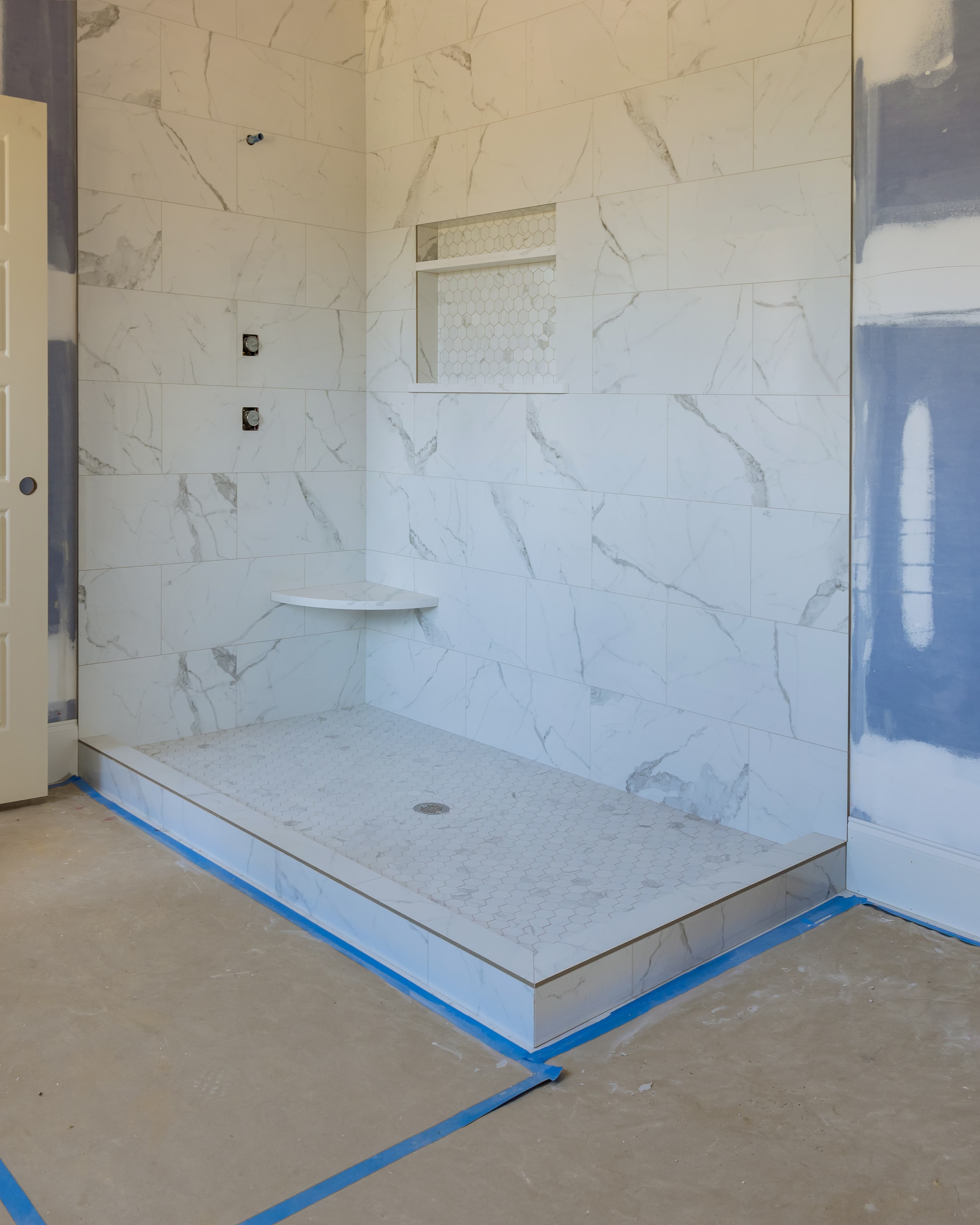 Residential bathroom shower being tiled during a remodel